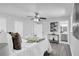 Bright bedroom features a ceiling fan, modern decor, and an ensuite bathroom at 4890 Old Briar Trl, Douglasville, GA 30135