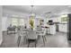 View of the dining area adjacent to the kitchen, featuring modern lighting fixtures at 4890 Old Briar Trl, Douglasville, GA 30135