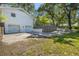 Side exterior of a charming white brick house with a two car garage and lush greenery around the property at 4890 Old Briar Trl, Douglasville, GA 30135