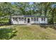 Charming, single-story home with a freshly painted white brick exterior and a well-maintained lawn at 4890 Old Briar Trl, Douglasville, GA 30135