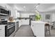 Bright, modern kitchen with stainless steel appliances, white cabinets, and a breakfast bar at 4890 Old Briar Trl, Douglasville, GA 30135
