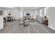 An open-concept floor plan with neutral colors and wood-look flooring at 4890 Old Briar Trl, Douglasville, GA 30135