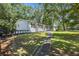 View of the back of the home with a walkway leading to the backyard at 4890 Old Briar Trl, Douglasville, GA 30135