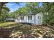 Well-manicured lawn surrounds this charming, single-story home with freshly painted white brick exterior at 4890 Old Briar Trl, Douglasville, GA 30135