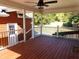 Relaxing covered back porch with ceiling fan and wood flooring provides a serene outdoor space at 893 Andrews Dr, Conyers, GA 30012