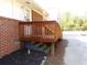 Sturdy wooden deck with stairs down to the yard, offering outdoor space by a brick exterior at 893 Andrews Dr, Conyers, GA 30012