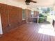 Enjoy outdoor living on this covered patio, featuring a fan and brick exterior at 893 Andrews Dr, Conyers, GA 30012