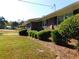 Charming brick home with manicured landscaping, including bushes under the windows at 893 Andrews Dr, Conyers, GA 30012