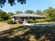 Traditional brick home with a covered front porch, manicured bushes, and a lush green lawn at 893 Andrews Dr, Conyers, GA 30012