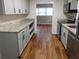 Galley kitchen featuring shaker cabinets, granite countertops, and stainless steel appliances at 893 Andrews Dr, Conyers, GA 30012