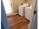 Efficient laundry room with modern appliances, wood flooring, and natural light at 893 Andrews Dr, Conyers, GA 30012