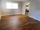 Inviting living room with wood flooring and convenient access to the kitchen at 893 Andrews Dr, Conyers, GA 30012