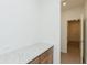 Hallway with white trim and a gray granite countertop on built in desk at 6545 Rhett Run, Cumming, GA 30028