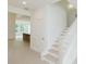 Bright entryway with staircase and open view to the living area, creating a welcoming atmosphere at 6545 Rhett Run, Cumming, GA 30028