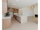Open concept kitchen features a large island, stainless appliances, and fireplace in background at 6545 Rhett Run, Cumming, GA 30028