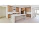 Open kitchen featuring an island, ample counter space, stainless vent hood, and wood cabinets at 6545 Rhett Run, Cumming, GA 30028