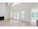 Open-concept living room boasts a fireplace and double doors leading to the deck at 6545 Rhett Run, Cumming, GA 30028
