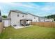 Spacious backyard with a covered patio featuring cozy seating, perfect for outdoor relaxation and entertaining at 149 Woodhouse Cir, Acworth, GA 30102