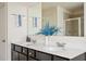 Well-lit bathroom featuring double sinks, a large mirror, and a glass-enclosed shower at 149 Woodhouse Cir, Acworth, GA 30102