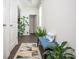 Inviting foyer with a bench, stylish rug, and houseplants, creating a warm and welcoming ambiance at 149 Woodhouse Cir, Acworth, GA 30102