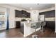 Modern kitchen with dark cabinets, granite countertops, and stainless steel appliances at 149 Woodhouse Cir, Acworth, GA 30102