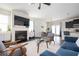 Comfortable living room featuring a fireplace, kitchen view, hardwood floors, and modern furnishings at 149 Woodhouse Cir, Acworth, GA 30102