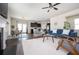 Spacious open-concept living area with a modern kitchen, dining space, fireplace, and comfortable seating at 149 Woodhouse Cir, Acworth, GA 30102
