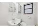 Bright white bathroom featuring a sleek vanity, mirrored medicine cabinet and a window providing natural light at 330 3Rd St # Apt 1, Atlanta, GA 30308