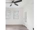 Bright bedroom with light gray floors, a ceiling fan, and windows, creating a cozy atmosphere at 330 3Rd St # Apt 1, Atlanta, GA 30308