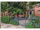 Charming brick building with lovely landscaping and a wrought iron fence and front garden at 330 3Rd St # Apt 1, Atlanta, GA 30308