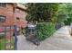 Brick apartment building with mature trees, sidewalk, and wrought iron fence around a front garden at 330 3Rd St # Apt 1, Atlanta, GA 30308