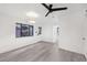 Bright living room boasts sleek gray floors, a modern ceiling fan, and a view of outdoor landscape at 330 3Rd St # Apt 1, Atlanta, GA 30308