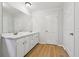 Bright bathroom featuring double vanity, laminate floors, and plenty of counter space at 56 Carlane Cir, Bowdon, GA 30108