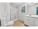 Well-lit bathroom features a shower stall, a toilet, and a vanity with a sink at 56 Carlane Cir, Bowdon, GA 30108