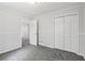 Neutral bedroom with gray carpet, overhead lighting, paneled walls and double closets at 56 Carlane Cir, Bowdon, GA 30108