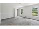 Neutral bedroom featuring plush gray carpeting, white trim, and natural light through windows at 56 Carlane Cir, Bowdon, GA 30108