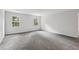 Spacious bedroom with plush carpet and natural light from two windows at 56 Carlane Cir, Bowdon, GA 30108