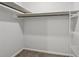 Walk-in closet featuring shelving and rod for organized storage at 56 Carlane Cir, Bowdon, GA 30108