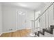 Foyer showcasing newly installed flooring, a staircase with white railings, and a bright, welcoming entrance at 56 Carlane Cir, Bowdon, GA 30108