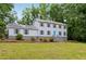 Exterior view of home with a metal roof, symmetrical windows, and a well-manicured front lawn at 56 Carlane Cir, Bowdon, GA 30108