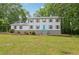 Charming home featuring two stories, a welcoming blue door, and a large, well-maintained front yard at 56 Carlane Cir, Bowdon, GA 30108