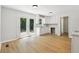 Clean kitchen with white cabinets, stainless sink, bright lighting, and an open design with access to backyard patio at 56 Carlane Cir, Bowdon, GA 30108