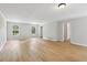 Generous living room area featuring light hardwood flooring and neutral paint throughout, providing a bright and airy space at 56 Carlane Cir, Bowdon, GA 30108