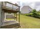 Large backyard with lawn and a wooden deck overlooking the backyard and a fence at 1530 Avalon Creek Rd, Sugar Hill, GA 30518