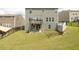 Spacious backyard featuring a deck, patio, lawn, and fenced perimeter, perfect for outdoor living at 1530 Avalon Creek Rd, Sugar Hill, GA 30518