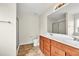 Bright bathroom featuring double sinks, wood cabinets, and separate shower at 1530 Avalon Creek Rd, Sugar Hill, GA 30518