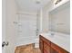 Bright bathroom features a shower-tub combo, vanity with sink, and vinyl floors at 1530 Avalon Creek Rd, Sugar Hill, GA 30518