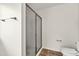 Bathroom featuring frosted glass shower door and toilet at 1530 Avalon Creek Rd, Sugar Hill, GA 30518