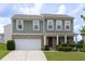 Charming two-story home featuring an attached two-car garage, manicured lawn and inviting front porch at 1530 Avalon Creek Rd, Sugar Hill, GA 30518
