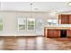 Open-concept kitchen with stainless steel appliances, hardwood floors, and natural light at 1530 Avalon Creek Rd, Sugar Hill, GA 30518